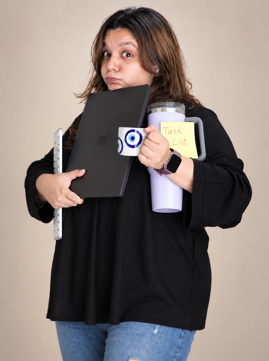 Mehak juggling laptop, coffee, and a task list